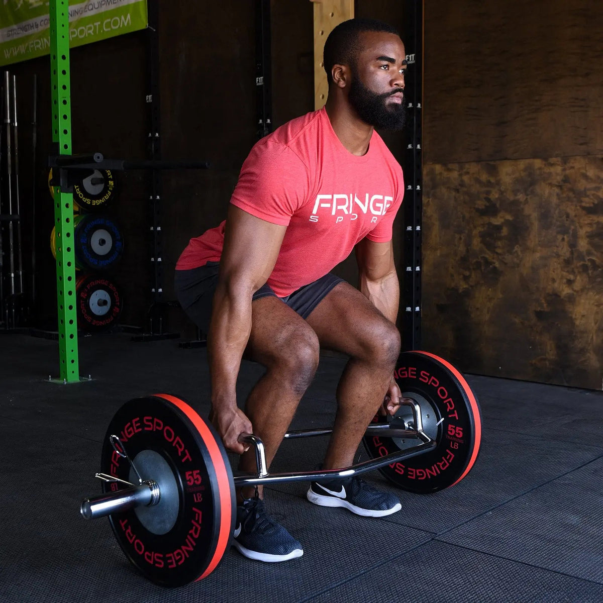 Athlete setting up a deadlift inside the Fringe Sport closed-frame Hex Bar