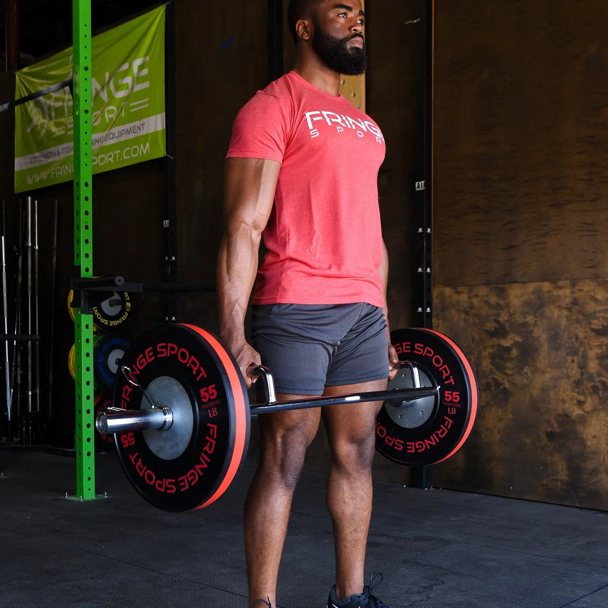 Athlete standing at lockout with the Fringe Sport Hex Bar